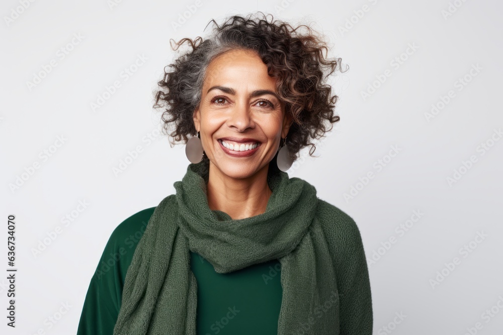Portrait of smiling woman with curly hair and green scarf over white background Portrait of smiling woman with curly hair and green scarf over white background