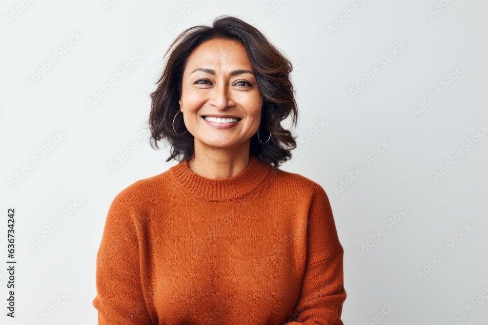 Portrait of a Indonesian woman in her 40s in a white background wearing a cozy sweater Portrait of a Indonesian woman in her 40s in a white background wearing a cozy sweater