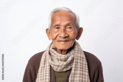 Portrait of an old Asian man with scarf on white background. © Eber Braun