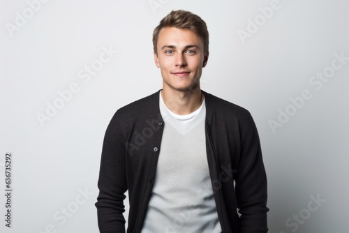 Obraz na płótnie Portrait of a handsome young man in a black sweater on a white background w salonie