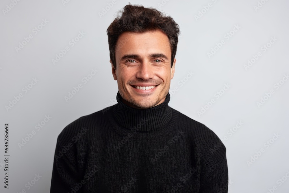 Portrait of a handsome young man in black sweater smiling and looking at camera isolated over white background Portrait of a handsome young man in black sweater smiling and looking at camera isolated over white background