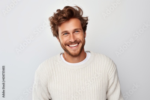 Portrait of a Russian man in his 30s in a white background wearing a cozy sweater