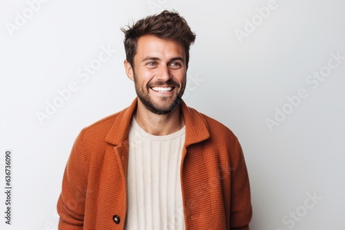 Portrait of a happy young man smiling at camera isolated over white background