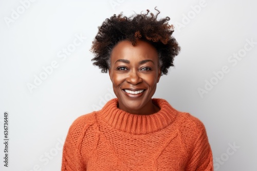 Beautiful african american woman with afro hairstyle and orange sweater