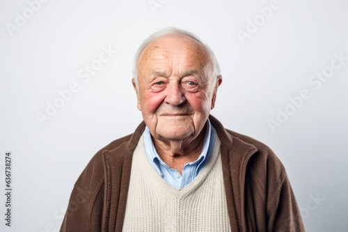 Portrait of a senior man in a sweater on a white background