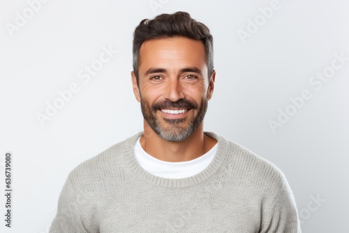 Portrait of a handsome man smiling and looking at camera over white background