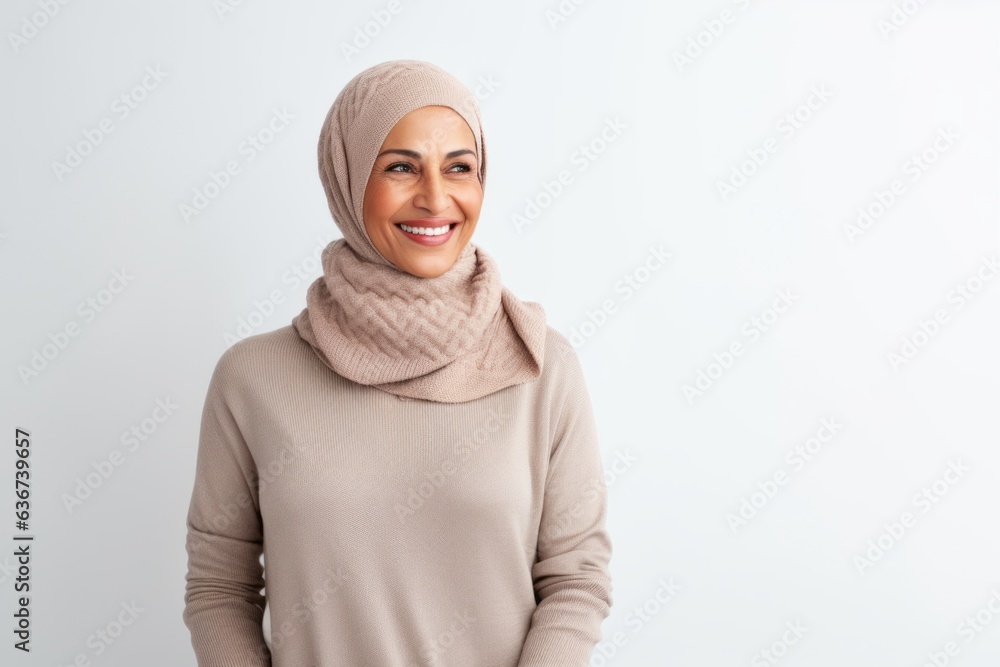 portrait of happy muslim woman in hijab looking at camera isolated on white