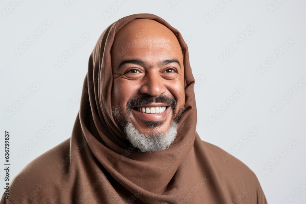 Portrait of a smiling middle-eastern man wearing hijab isolated on a white background Portrait of a smiling middle-eastern man wearing hijab isolated on a white background
