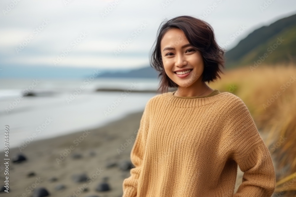 Portrait of a smiling young asian woman standing on the beach Stock ...