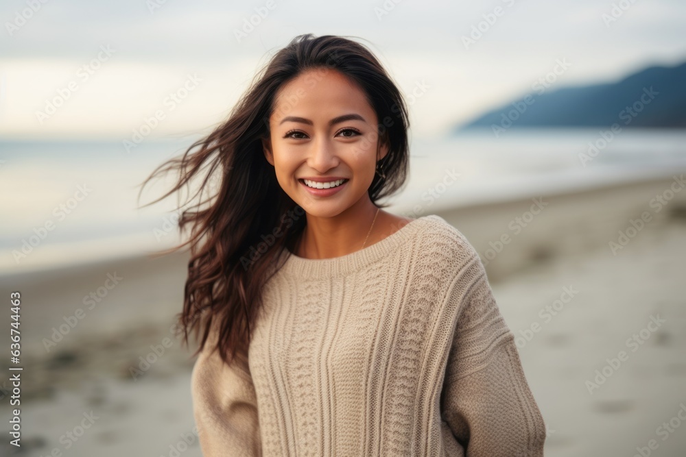 Portrait of a beautiful young asian woman smiling at the beach Portrait of a beautiful young asian woman smiling at the beach