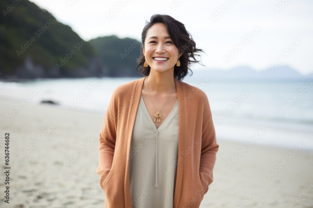Portrait of smiling asian woman standing on the beach at seaside Portrait of smiling asian woman standing on the beach at seaside
