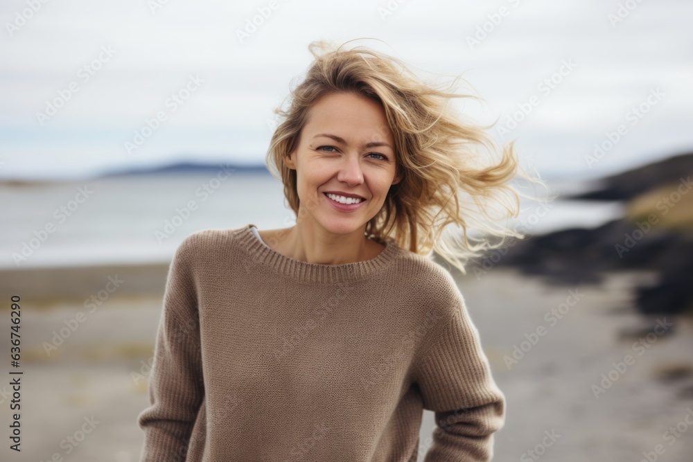 Portrait of a smiling young woman with blond hair at the beach Portrait of a smiling young woman with blond hair at the beach