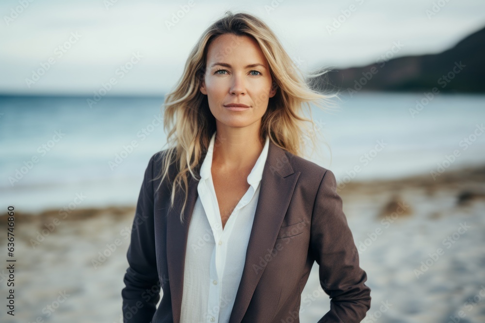 Portrait of a beautiful young businesswoman standing on the beach. Portrait of a beautiful young businesswoman standing on the beach.