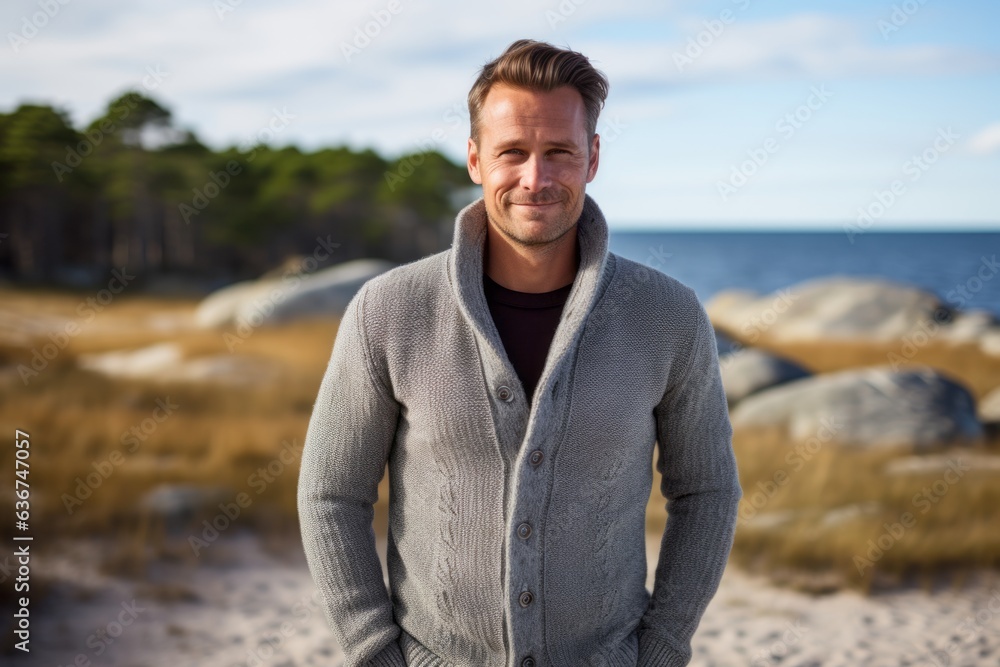 Portrait of a handsome man standing on the beach at autumn day Portrait of a handsome man standing on the beach at autumn day