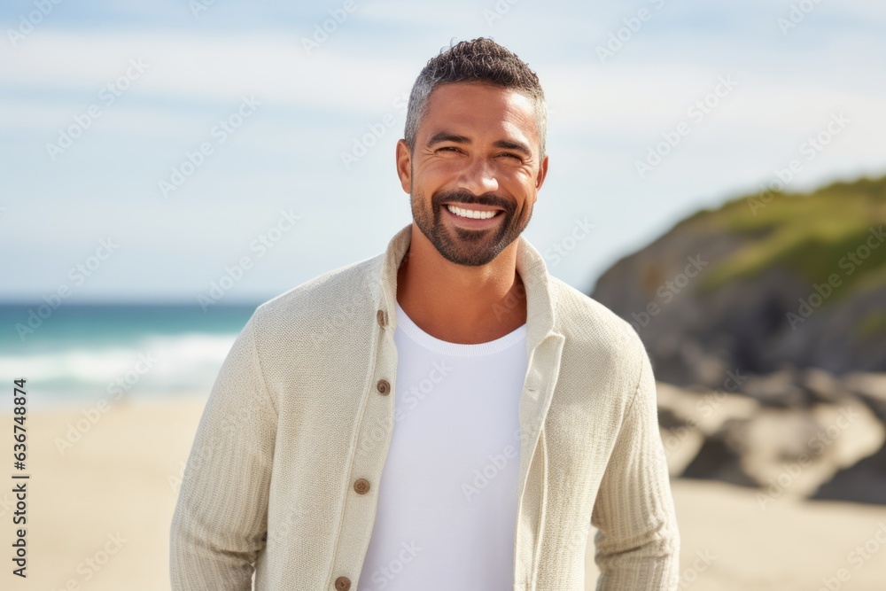 Portrait of handsome man smiling at the beach on a sunny day Portrait of handsome man smiling at the beach on a sunny day