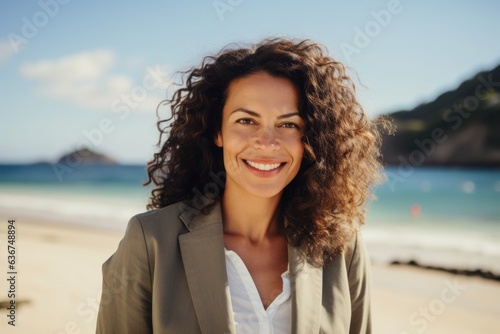 Portrait of smiling businesswoman standing on beach at the day time