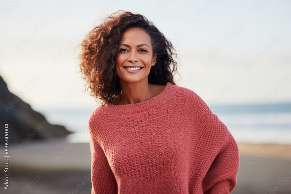 Portrait of a smiling young woman standing on the beach at sunset Portrait of a smiling young woman standing on the beach at sunset