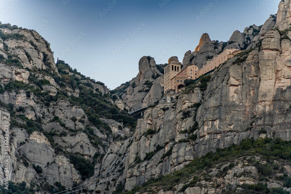 Low-angle view pf the famous Basilica de Monserrat on the high cliffs in Spain