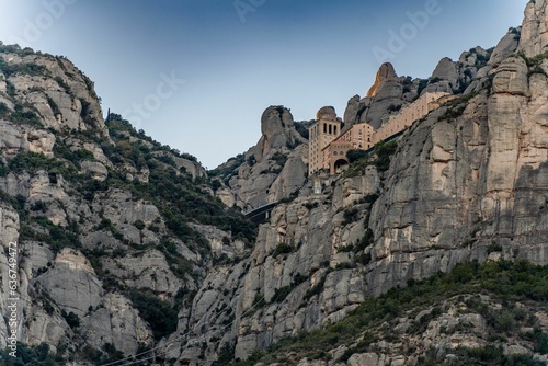 Low-angle view pf the famous Basilica de Monserrat on the high cliffs in Spain