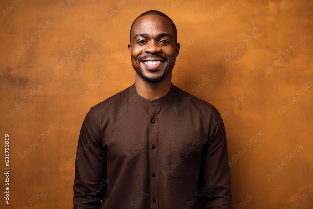Obraz premium Medium shot portrait of a Nigerian man in his 30s in an abstract background wearing a chic cardigan