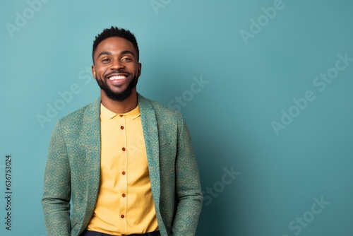Medium shot portrait of a Nigerian man in his 30s in an abstract background wearing a chic cardigan