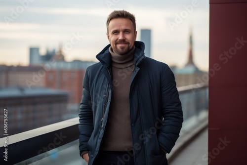 Portrait of a handsome bearded man in a blue jacket on the background of the Moscow Kremlin