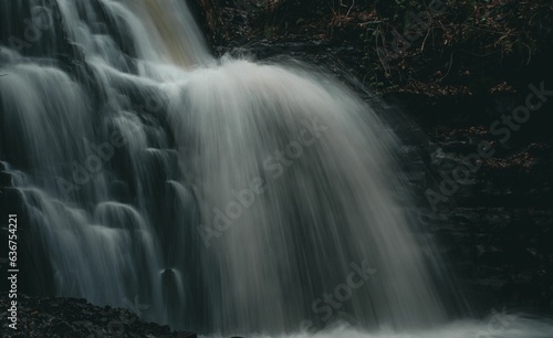 Scenic view of a waterfall cascading down the rocks in Mountain Ash  South Wales