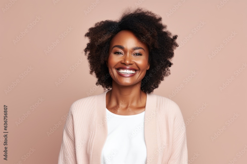 Portrait of a Nigerian woman in her 30s in a pastel or soft colors background wearing a chic cardigan Portrait of a Nigerian woman in her 30s in a pastel or soft colors background wearing a chic cardigan