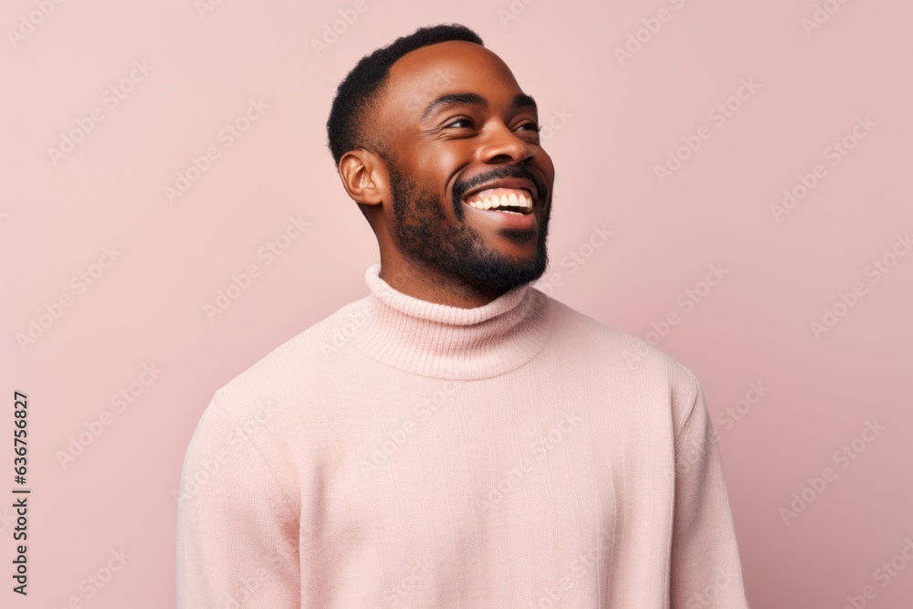 Portrait of a Nigerian man in his 30s in a pastel or soft colors background wearing a chic cardigan Portrait of a Nigerian man in his 30s in a pastel or soft colors background wearing a chic cardigan