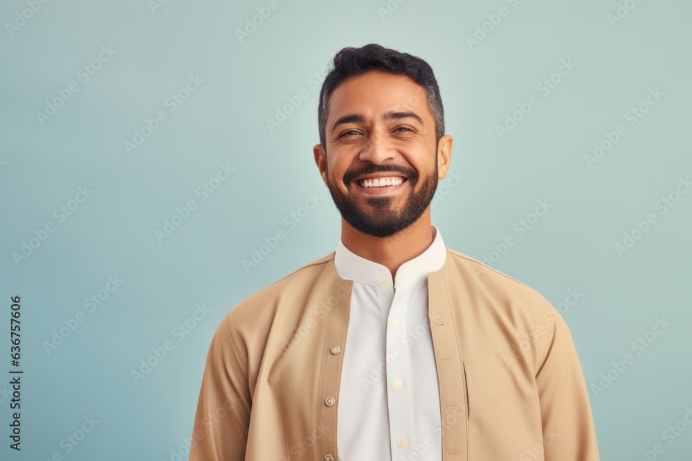 Portrait of a Saudi Arabian man in his 30s in a pastel or soft colors background wearing a chic cardigan Portrait of a Saudi Arabian man in his 30s in a pastel or soft colors background wearing a chic cardigan
