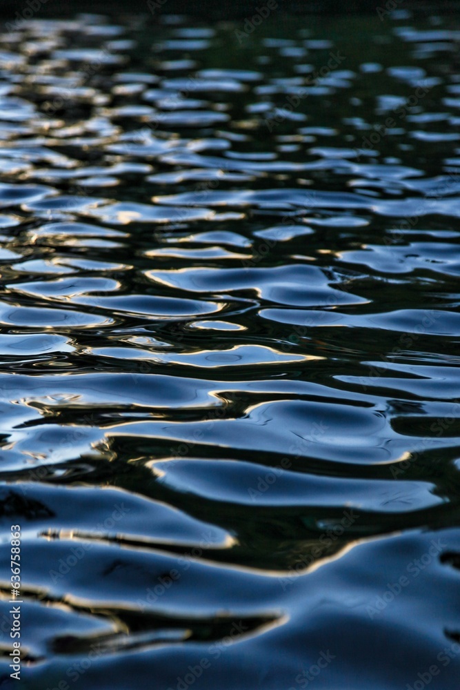 Tranquil body of water with the sun reflecting off the surface Tranquil body of water with the sun reflecting off the surface