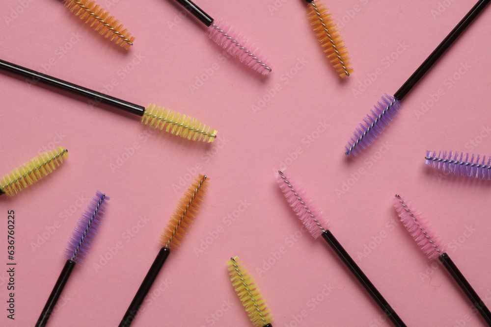 Set of brushes for combing eyelashes on pink background. Beauty concept Set of brushes for combing eyelashes on pink background. Beauty concept
