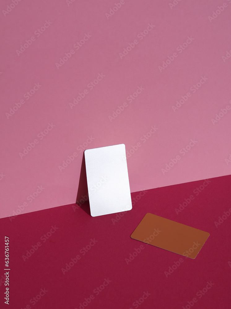 Metallic and golden business cards on pink background with shadow. Creative layout, minimalism Metallic and golden business cards on pink background with shadow. Creative layout, minimalism