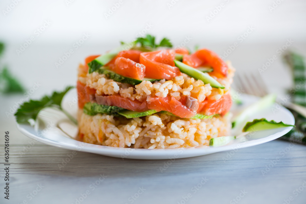 Boiled white rice with salted red fish, cucumbers and other vegetables with herbs in a plate. Boiled white rice with salted red fish, cucumbers and other vegetables with herbs in a plate.