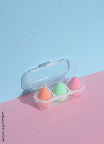 Makeup sponge blenders in pack on a pink blue background with shadow. Beauty concept. Creative layout, minimalism