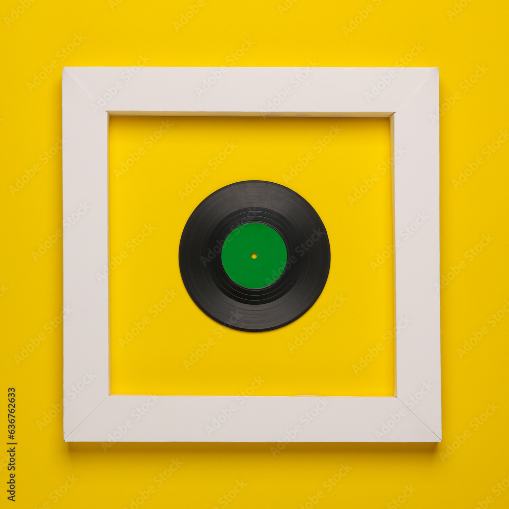 Obraz premium Vinyl record in white frame on yellow background. Creative layout. Minimalism