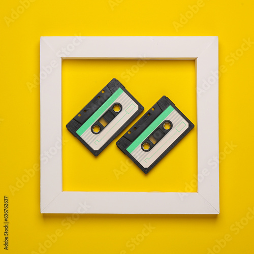 Retro Audio cassettes in white frame on yellow background. Creative layout. Minimalism