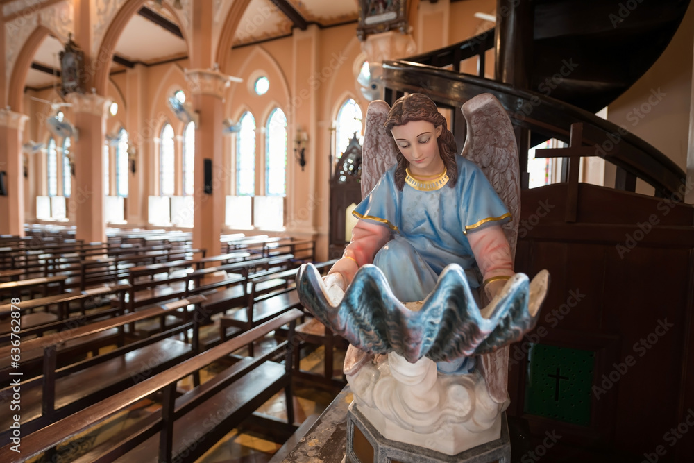 Virgin Mary statue with wing read bible book inside Catholic Church