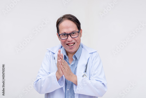 An evil, corrupt and mad doctor rubbing his hands together, relishing his money laundering scheme. A scam or quack doctor of asian descent, middle aged male. Isolated on a white background.