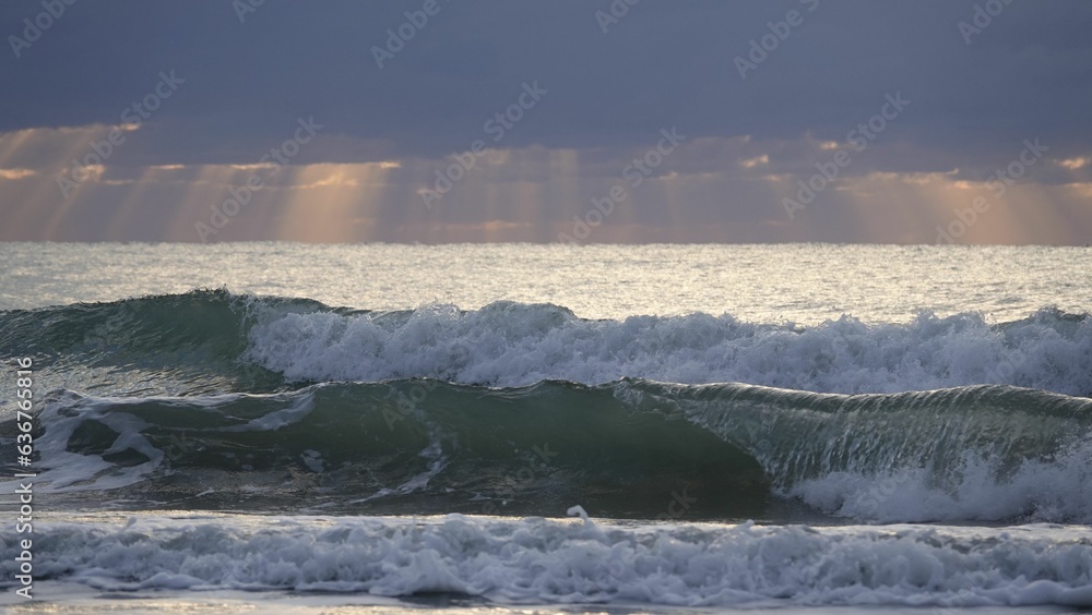 Picturesque scene of an ocean at dusk, with dark blue waves Picturesque scene of an ocean at dusk, with dark blue waves