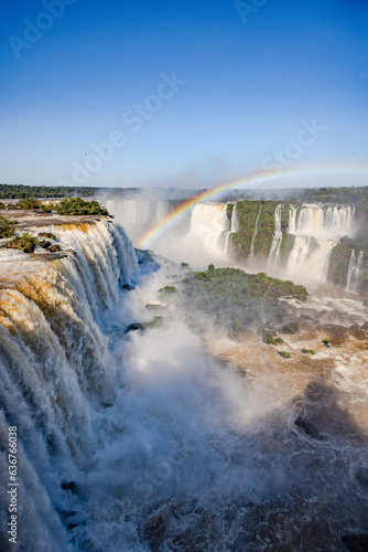 Perfect rainbow over Iguazu Waterfalls, one of the new seven natural wonders of the world in all its beauty viewed from the Brazilian side - traveling South America 