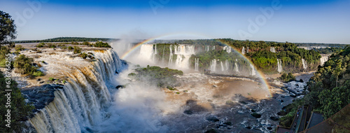 Perfect rainbow over Iguazu Waterfalls, one of the new seven natural wonders of the world in all its beauty viewed from the Brazilian side - traveling South America - Panorama