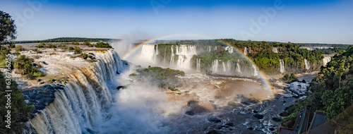 Perfect rainbow over Iguazu Waterfalls, one of the new seven natural wonders of the world in all its beauty viewed from the Brazilian side - traveling South America - Panorama photo