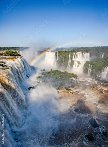 Perfect rainbow over Iguazu Waterfalls  one of the new seven natural wonders of the world in all its beauty viewed from the Brazilian side - traveling South America 