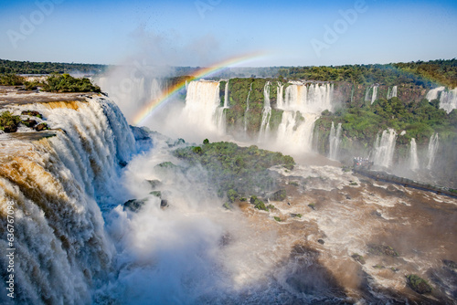 Perfect rainbow over Iguazu Waterfalls, one of the new seven natural wonders of the world in all its beauty viewed from the Brazilian side - traveling South America 