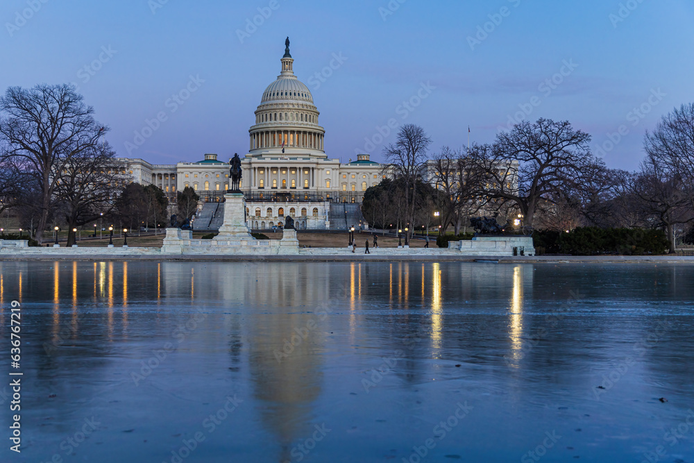 U.S. Capitol Building reflecting in frozen pool in Washington, DC USA