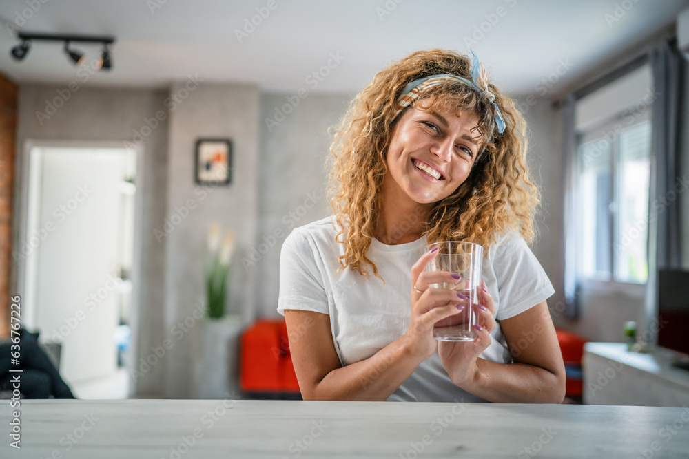 one adult caucasian woman sit at home hold glass of water happy smile one adult caucasian woman sit at home hold glass of water happy smile