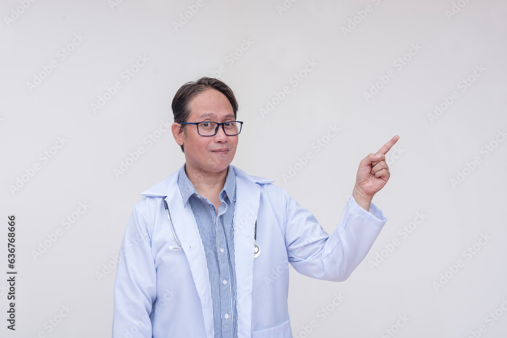 A doctor points to the right with his finger. Of asian descent, middle aged male in his 40s. entation or advertisement. Isolated on a white background. A doctor points to the right with his finger. Of asian descent, middle aged male in his 40s. entation or advertisement. Isolated on a white background.