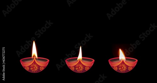 Three different burning oil lamps on a black background. Diwali celebration, festival of lights.