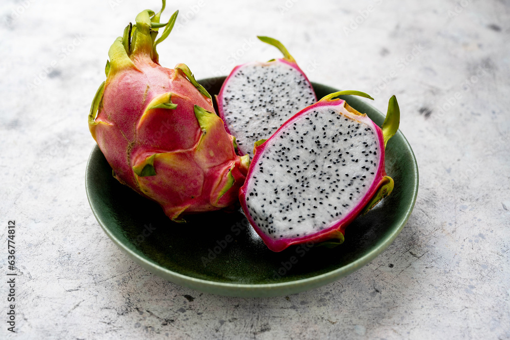 Dragon fruit sliced in halves, exotic dragon fruit in a plate Dragon fruit sliced in halves, exotic dragon fruit in a plate